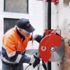 Construction worker cutting a wall with CARDI DV PE400-1500 blade saw on rail.