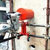 CARDI core drill fixed on a scaffolding (with special accessories) drills a wall