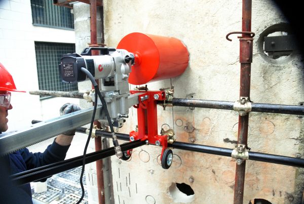 CARDI core drill fixed on a scaffolding (with special accessories) drills a wall